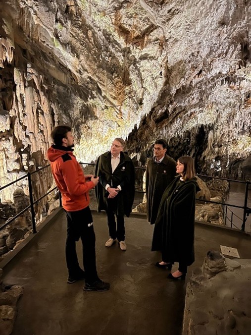 IOI President, Chris Field PSM, Human Rights Ombudsman of the Republic of Slovenia, Peter Svetina, and Chief of Staff to the IOI President, Rebecca Poole, being provided a guided tour of Postojna Cave.